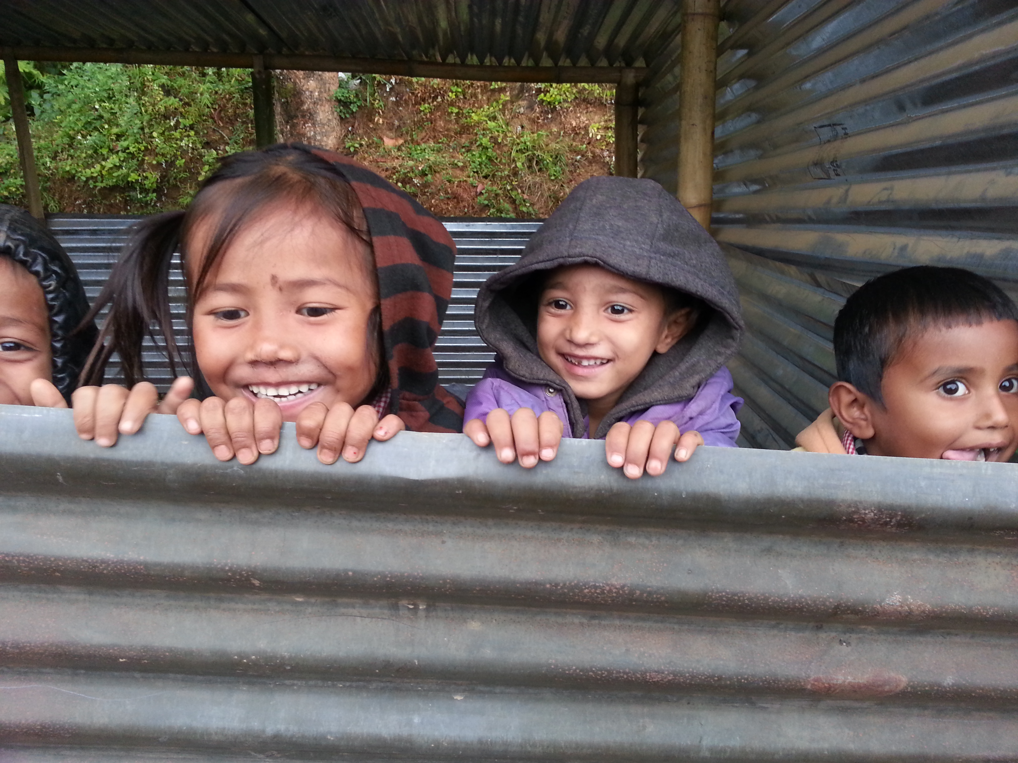Children of the village in their tin hut classrooms, waiting for the school to reopen